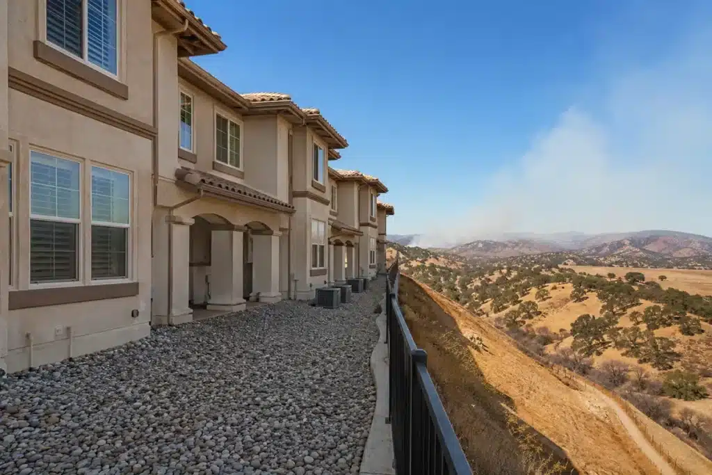 HOA townhome with compliant Zone 0 gravel perimeter in California wildfire zone